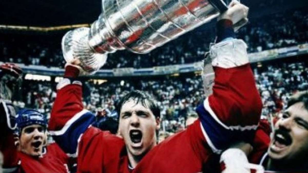 Patrick Roy making a dramatic pad save in the 1986 Stanley Cup playoffs, young goalie wearing Canadiens mask and vintage pads