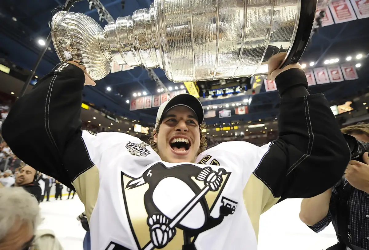 Sidney Crosby hoisting the Stanley Cup above his head after the Penguins' 2009 Game 7 victory