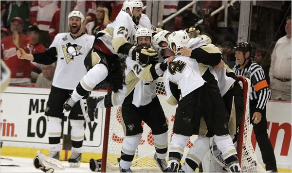 Pittsburgh Penguins players celebrating together on the ice after winning Game 7 of the 2009 Stanley Cup Final