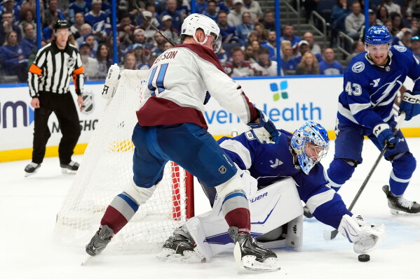 Colorado Avalanche and Tampa Bay Lightning players battle for the puck at a Stanley Cup Final faceoff