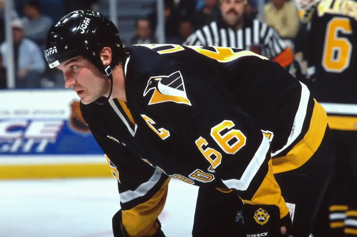 Mario Lemieux gliding on ice with effortless stride and puck control during a game