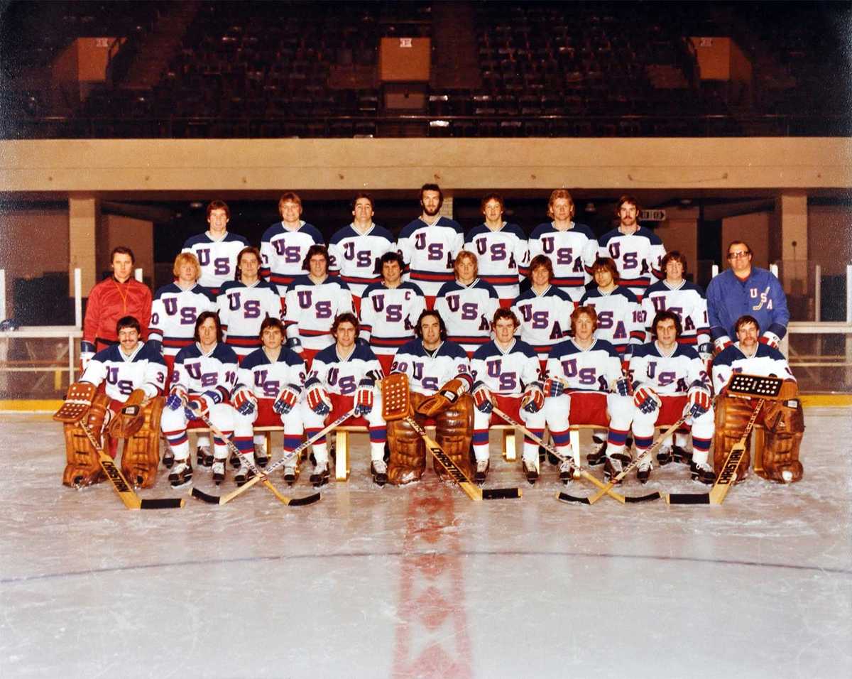 1980 U.S. Olympic hockey team in a tight locker-room huddle before a game