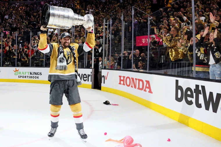 Team members embracing and celebrating on the ice after winning the Stanley Cup