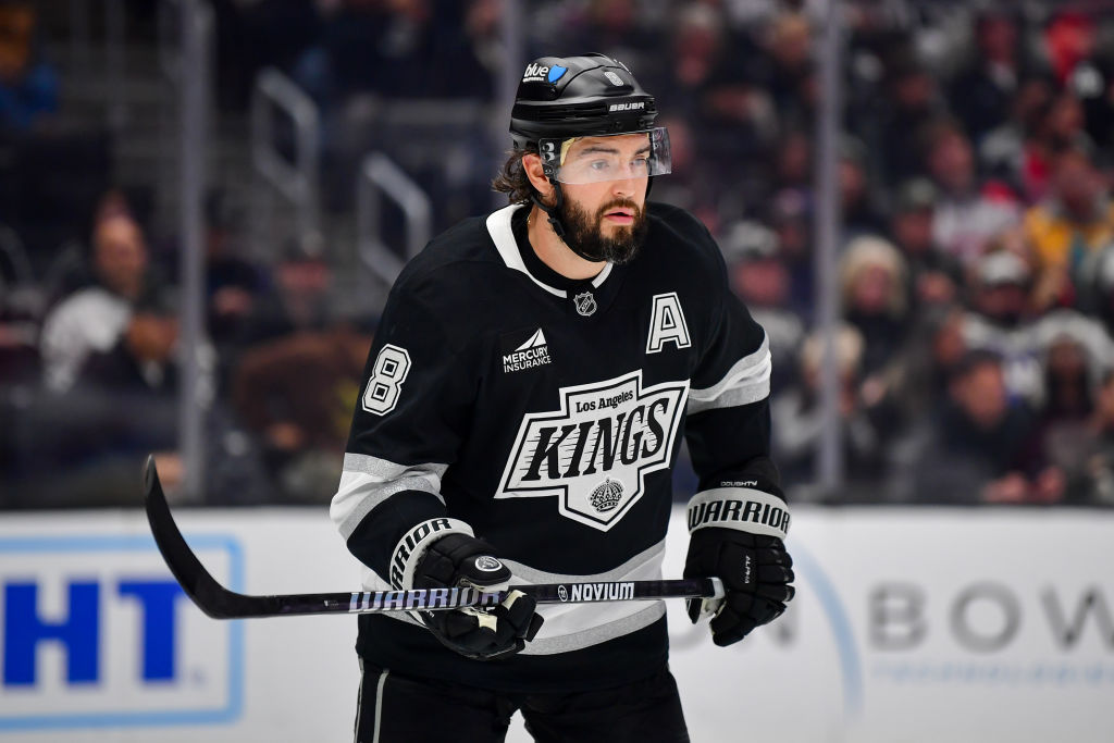 Los Angeles Kings players wearing the original 1967 black and gold jerseys on the ice at their inaugural season