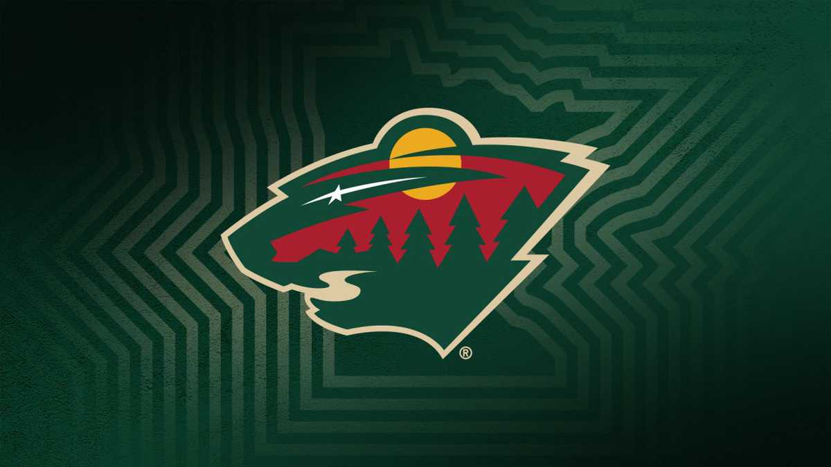 Early Minnesota Wild logo on display during the team's 2000 reveal event with fans gathered in arena